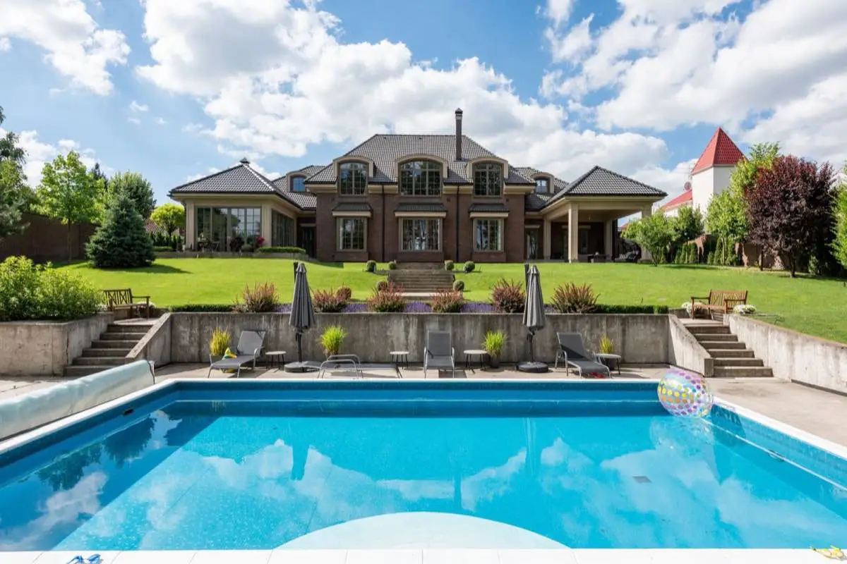 Paver pool deck around a backyard swimming pool in Santa Clarita, CA